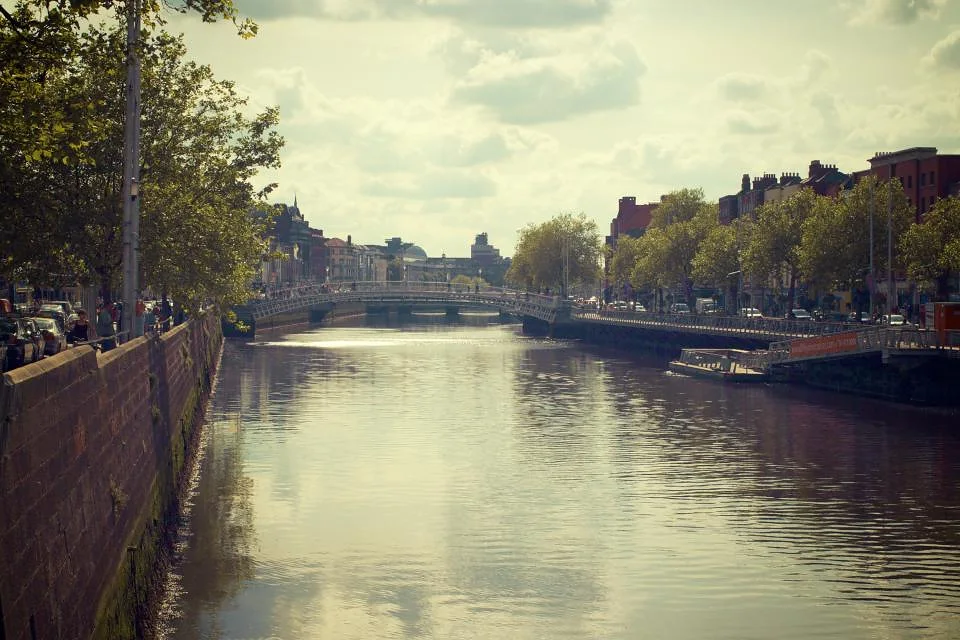The River Liffey in Dublin on a bright day, with trees along the quays